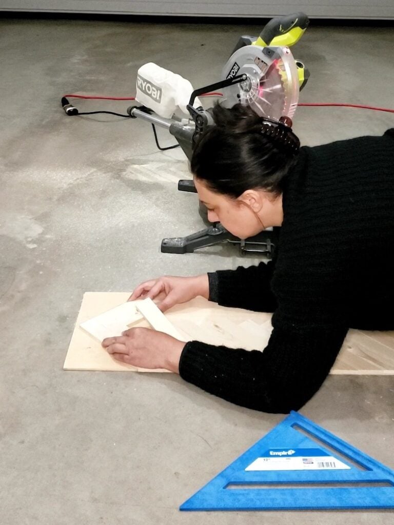 Arranging small wood pieces to form a herringbone pattern