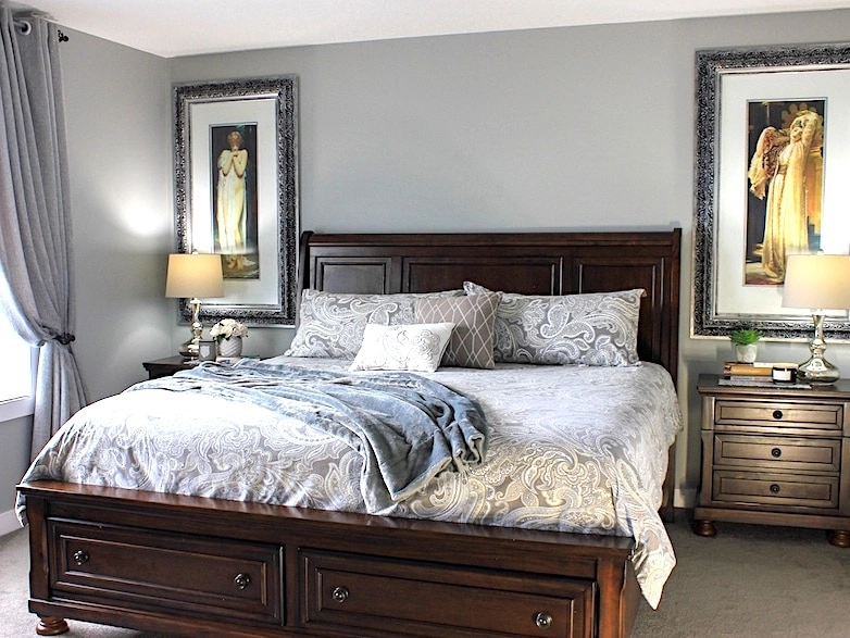 small master bedroom with a king size bed and oversized art