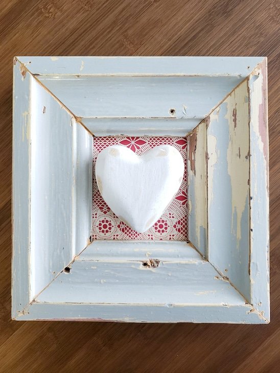 DIY wall decor. White wooden heart in reclaimed wood frame