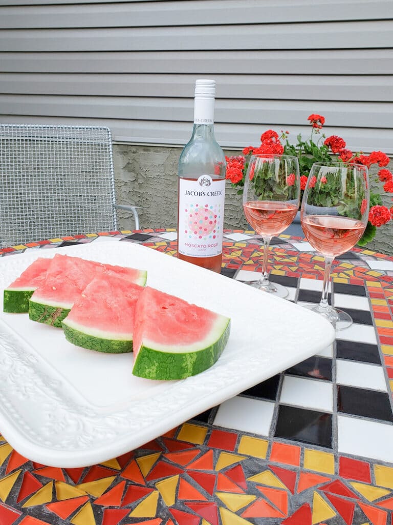Watermelon and rose served at an outdoor sitting area
