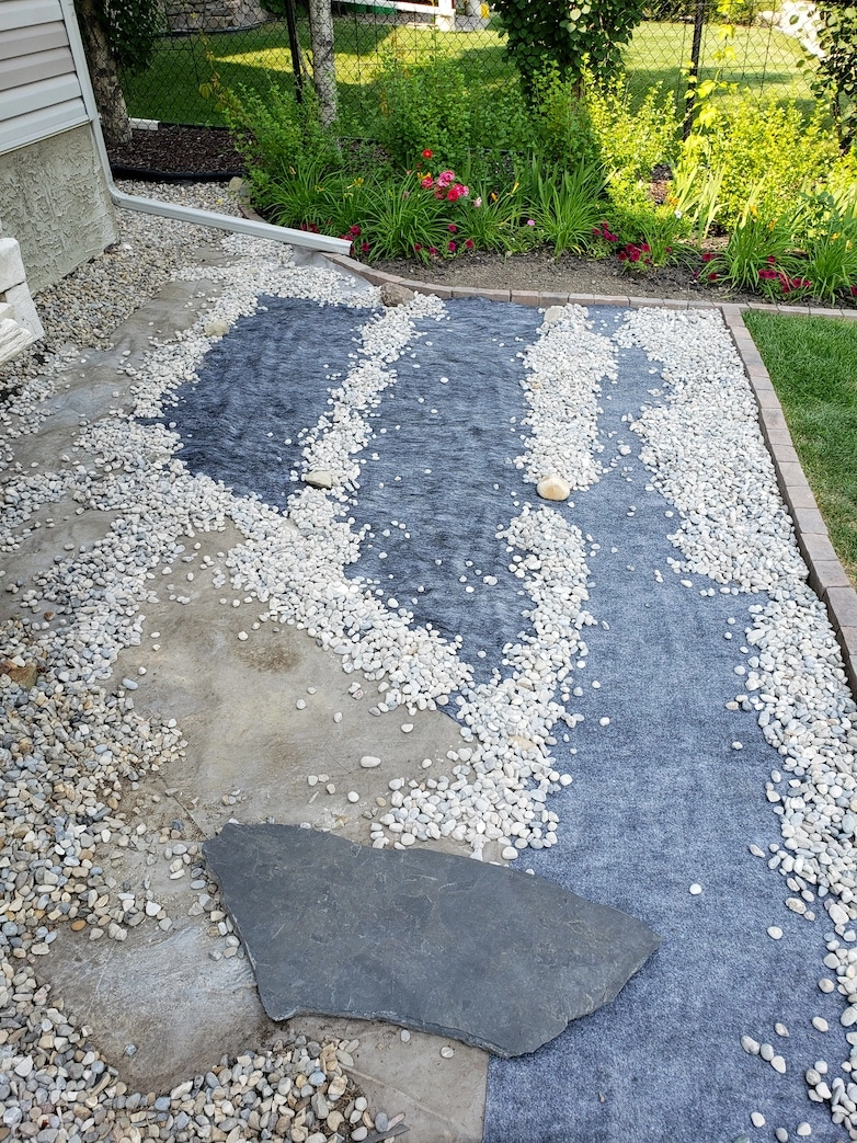 Placing pea gravel on top of landscaping fabric