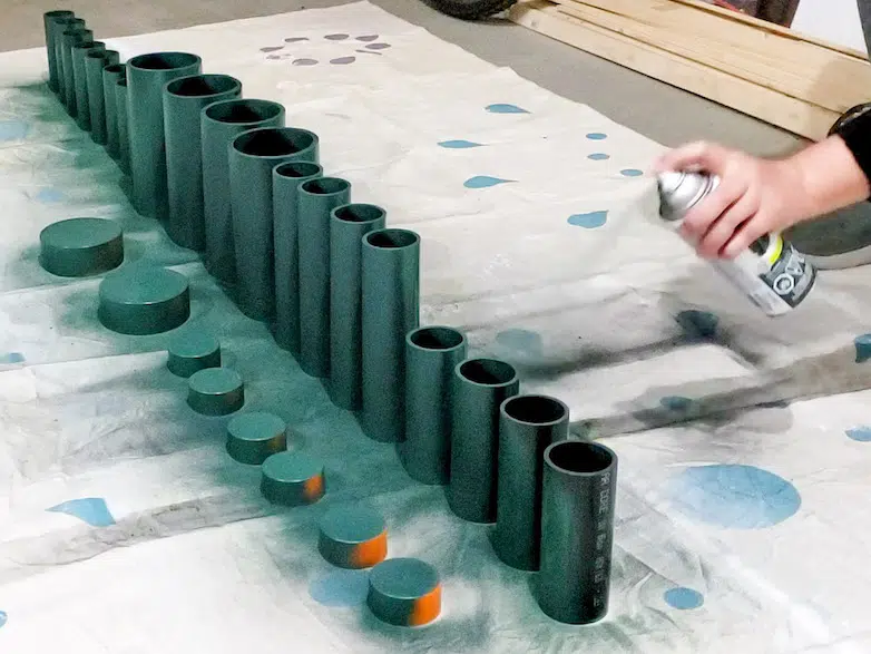 Spray painting pieces of PVC pipe