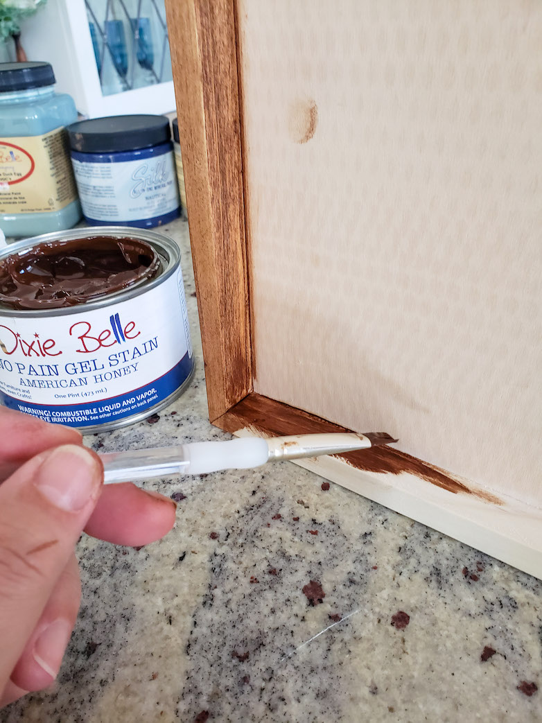 Applying wood stain to the edge of a wooden tray