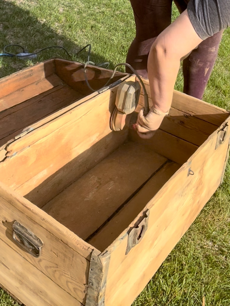 Sanding the inside of a vintage trunk