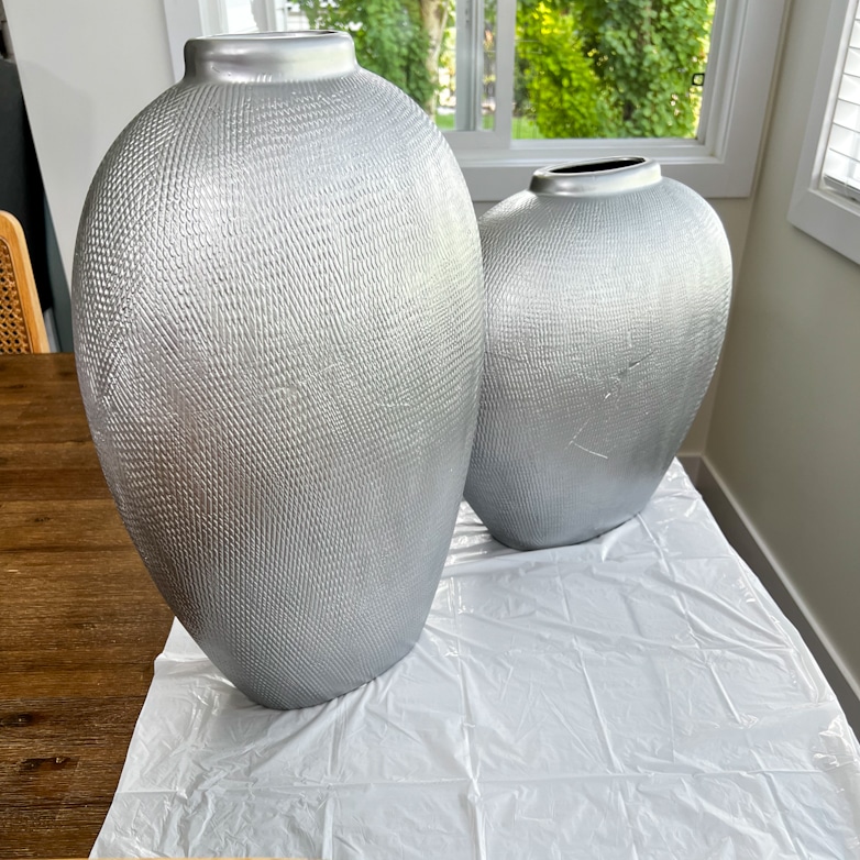 Two silver painted ceramic vases