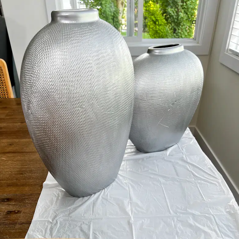 Two silver painted ceramic vases
