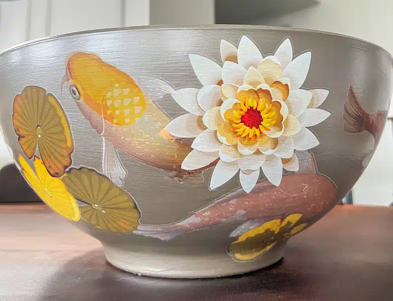 A decorative bowl decorated with transfers seen from the outside