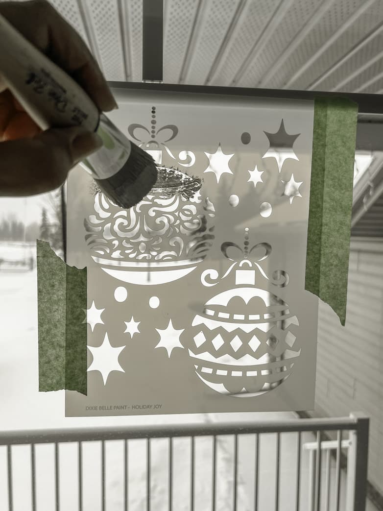 Stencilling a window with Christmas baubles