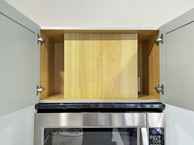 Open cabinet above over-the-range microwave
