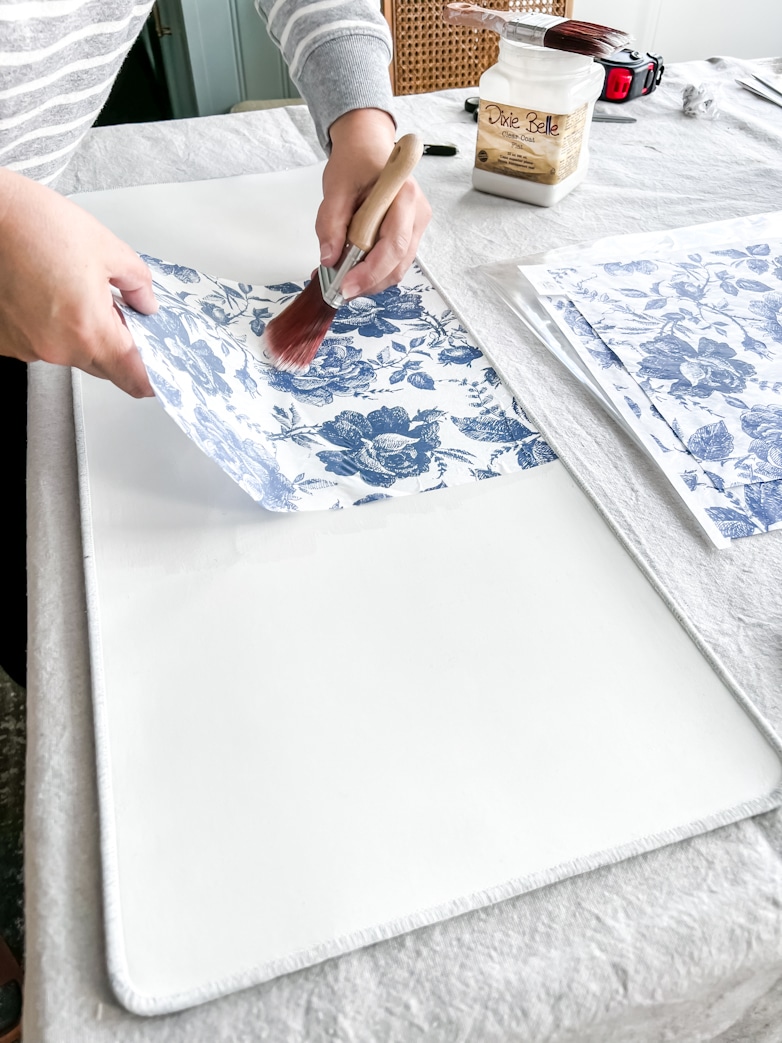 Smoothing out the decoupage rice paper witha clean paint brush
