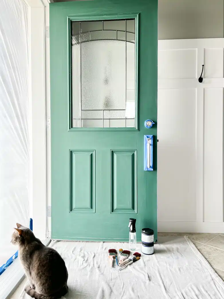 Green front door prepared to be painted