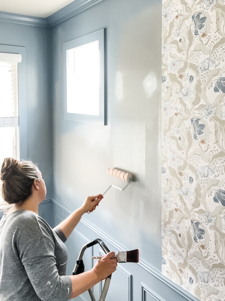 Applying wallpaper paste to the wall
