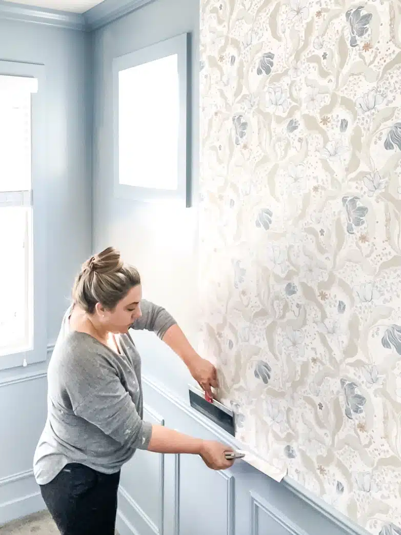 Cutting off the excess wallpaper at top and bottom 