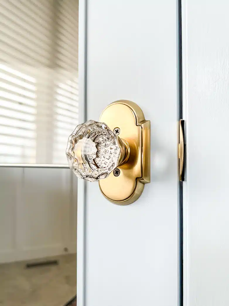 Newly installed door knob with brass and glass detail