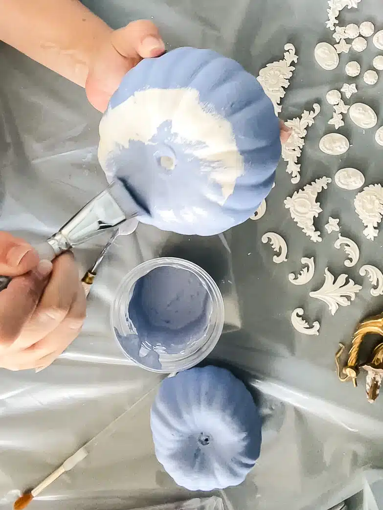 Painting faux pumpkins with blue paint. Imitating a look inspired by Wedgwood Jasperware