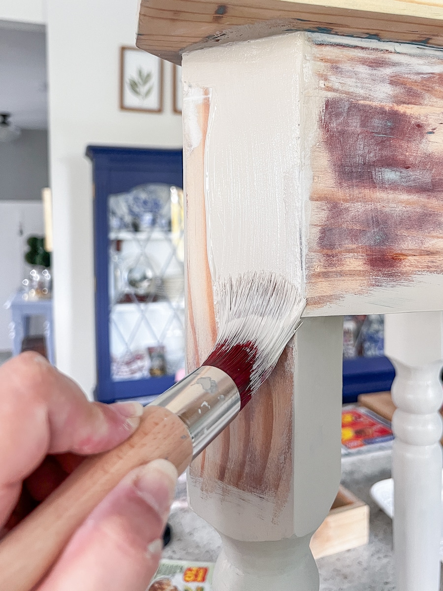 Painting a sanded down corner table with chalk paint in a sand color