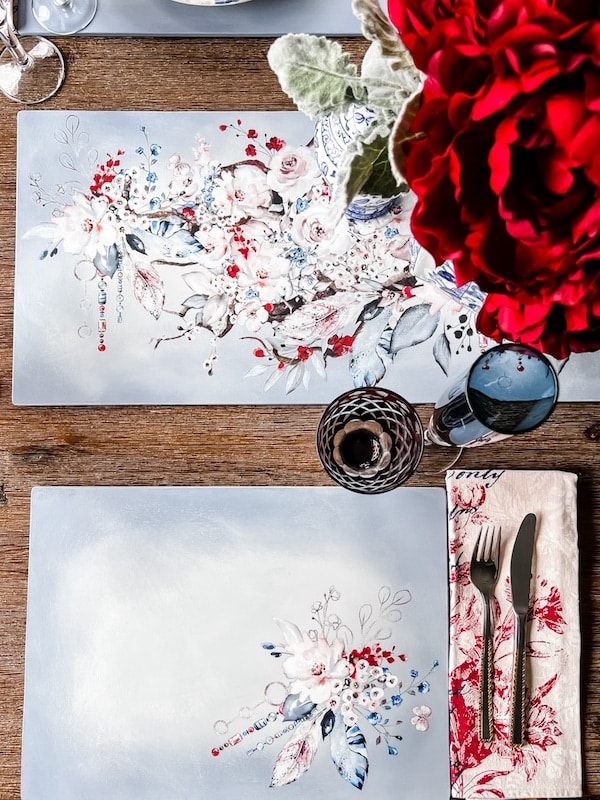 Light blue custom made placemats decorated with blue, red and white transfer images.