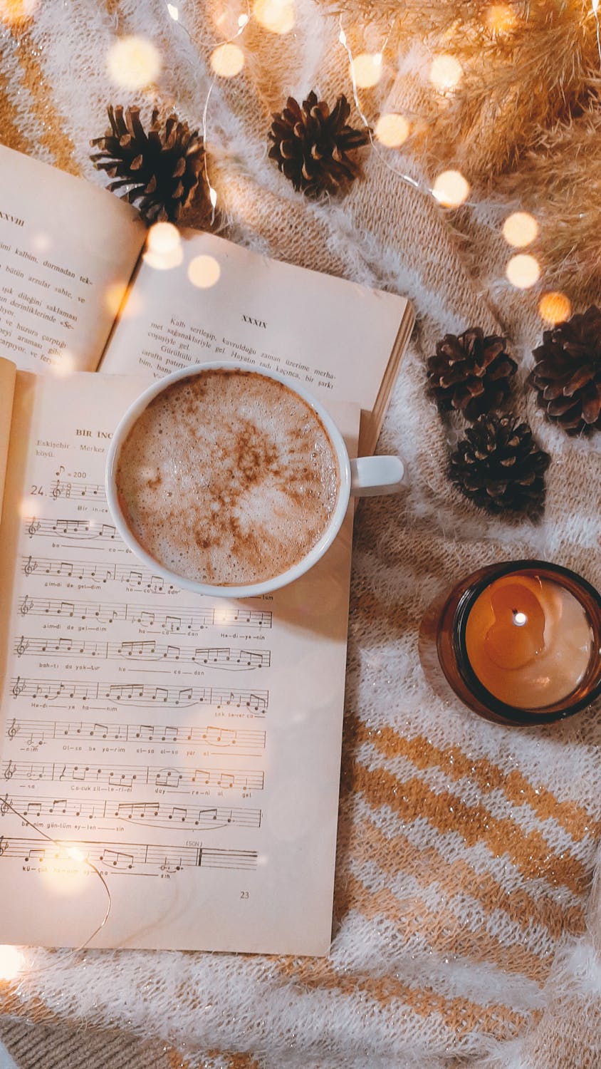 A cup of coffee on a christmas music sheet