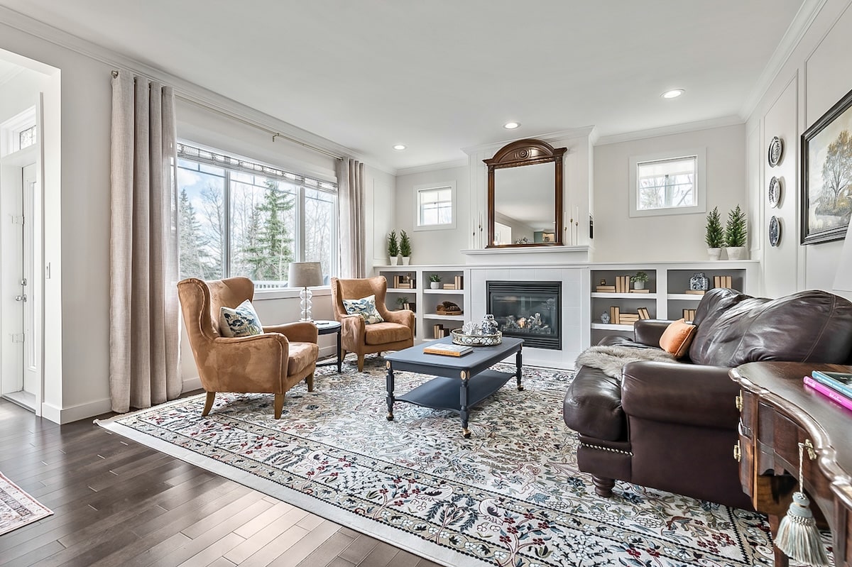 A living room with a fireplace and leather furniture
