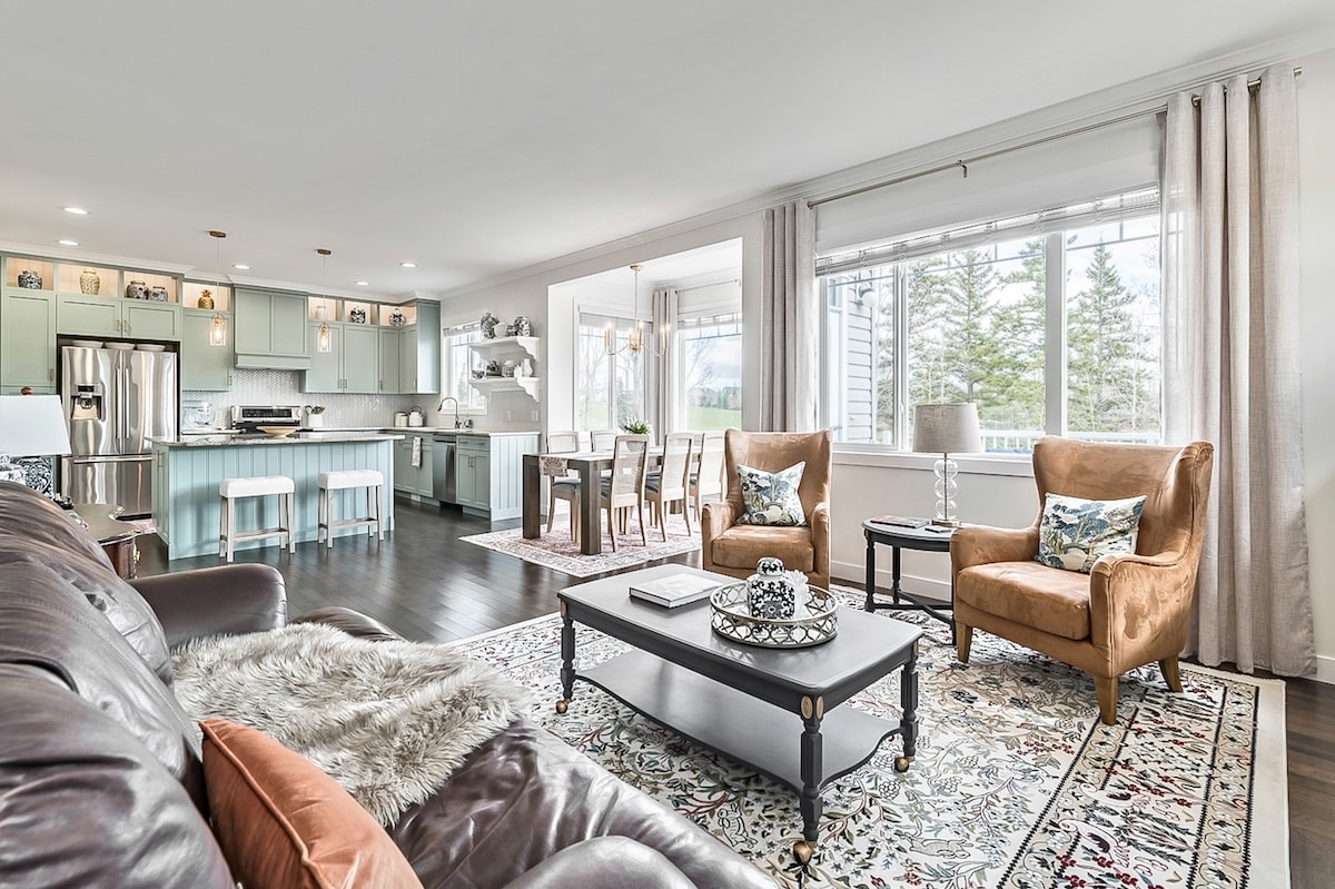 A living room with a couch and chairs