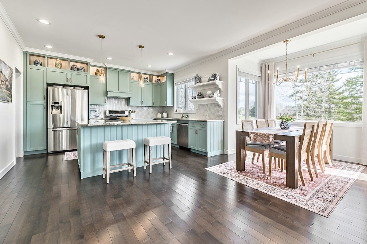 A kitchen and dining room with a table and chairs
