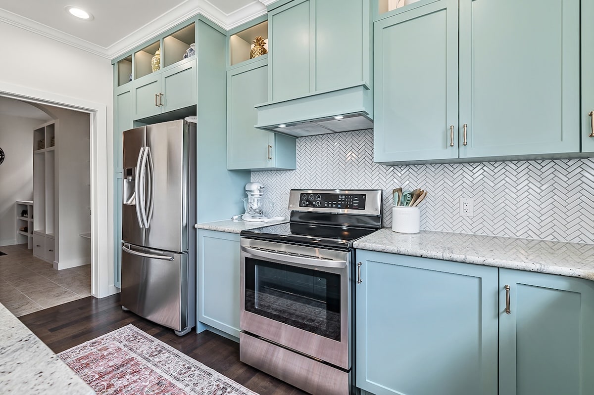 A kitchen with blue cabinets and a stove