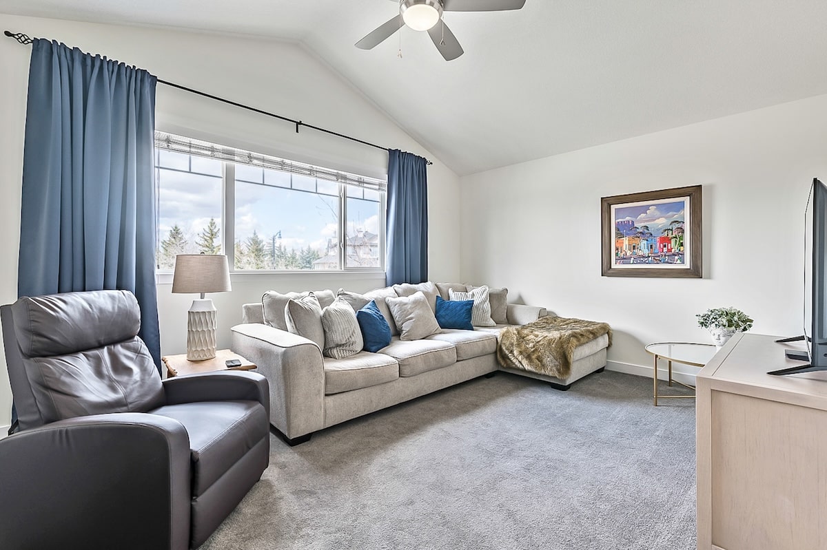 A living room with a couch and a fan