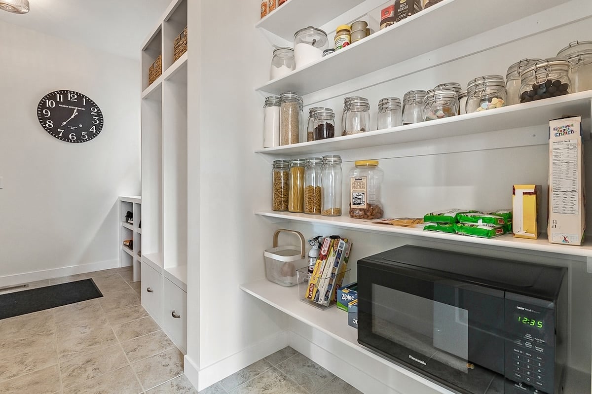 A kitchen with shelves and food items