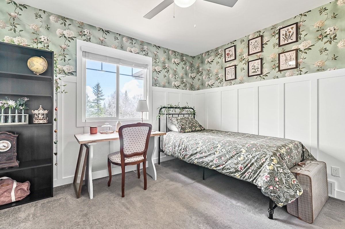 A bedroom with a bed and desk